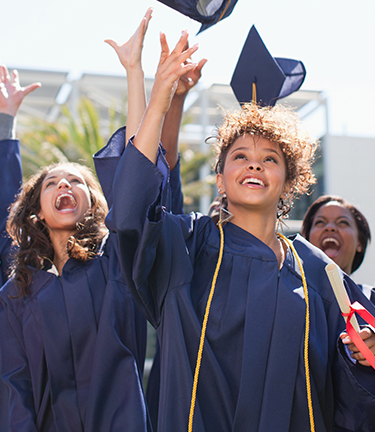 Graduating from college throwing her cap in the air